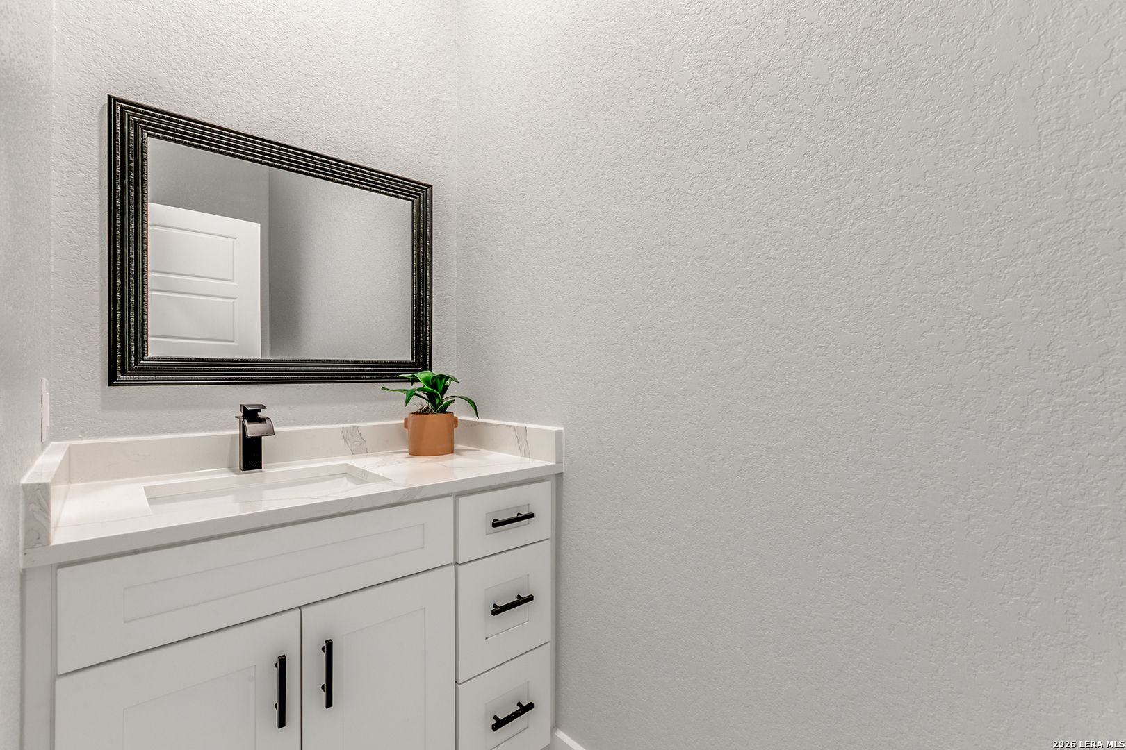 16934 Rancho Atascosa, TX 78002 - Photo 12 of 27 a bathroom with a sink and a mirror