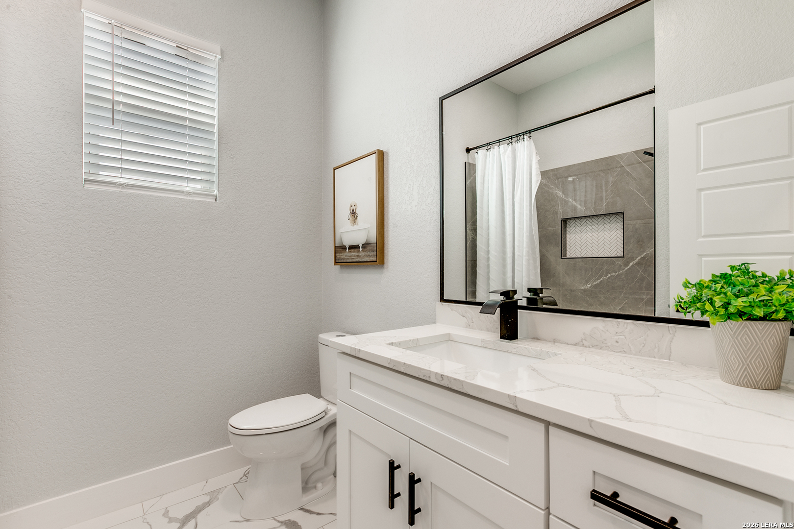 16934 Rancho Atascosa, TX 78002 - Photo 21 of 27 a bathroom with a granite countertop sink vanity mirror and toilet