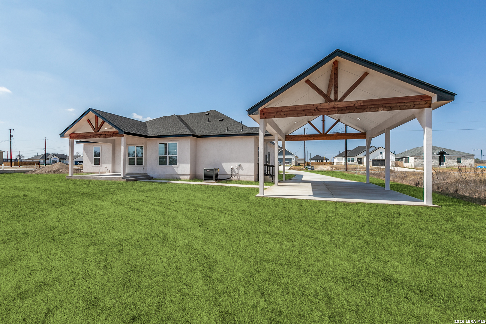 16934 Rancho Atascosa, TX 78002 - Photo 24 of 27 a front view of a house with a yard table and chairs