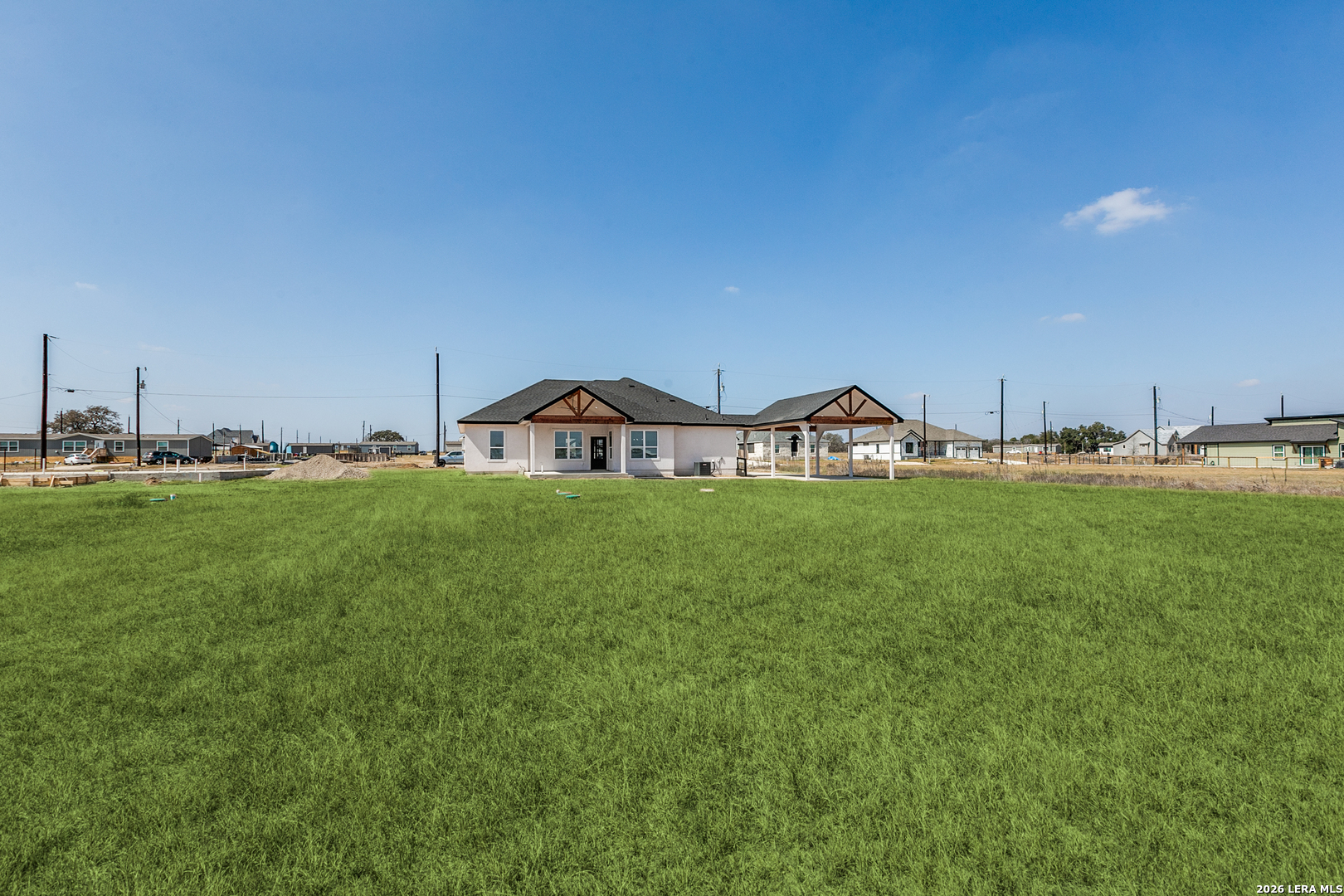 16934 Rancho Atascosa, TX 78002 - Photo 25 of 27 a view of a house with a yard and sitting area