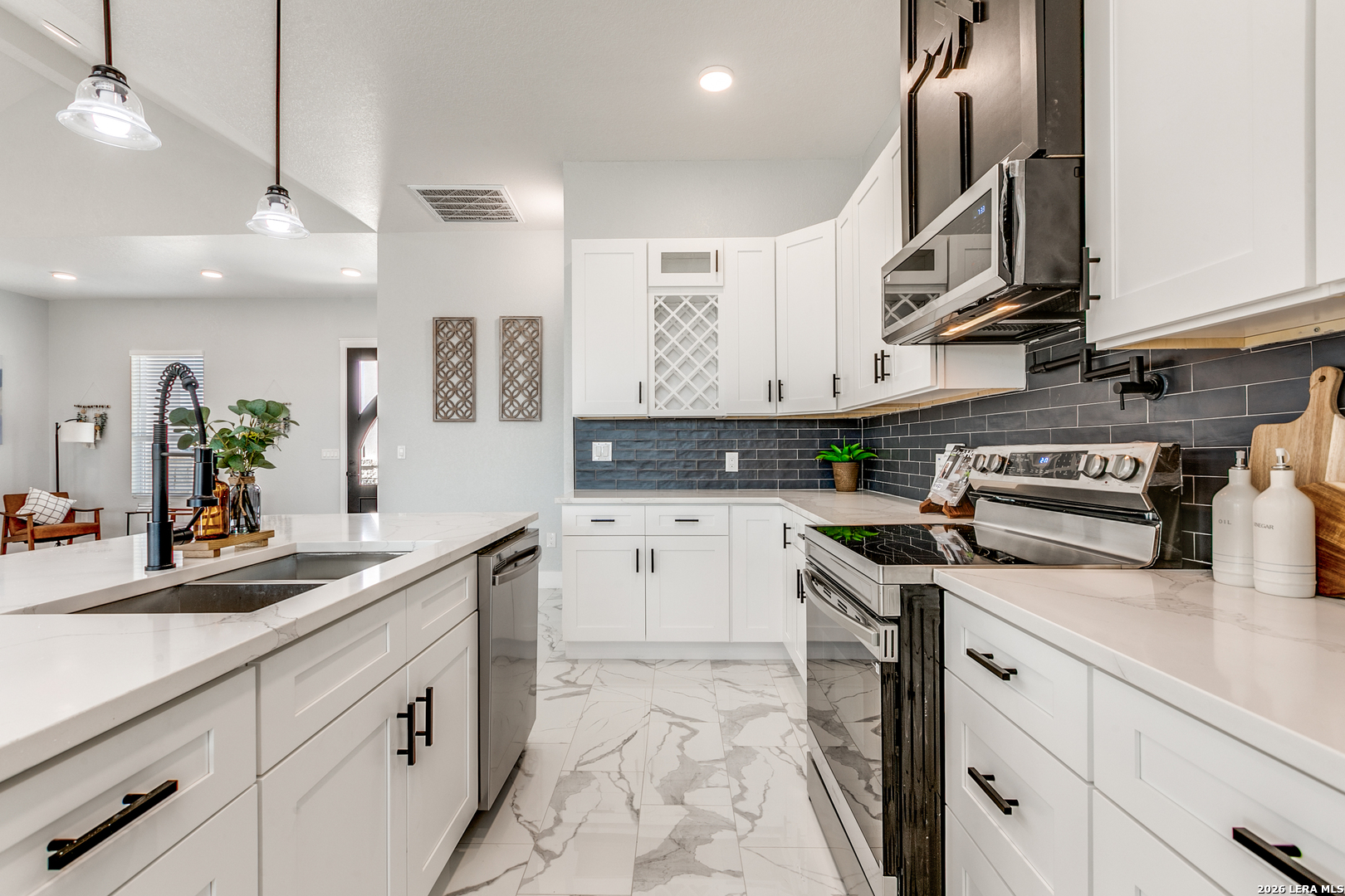 16934 Rancho Atascosa, TX 78002 - Photo 7 of 27 a kitchen with stainless steel appliances granite countertop a sink and cabinets