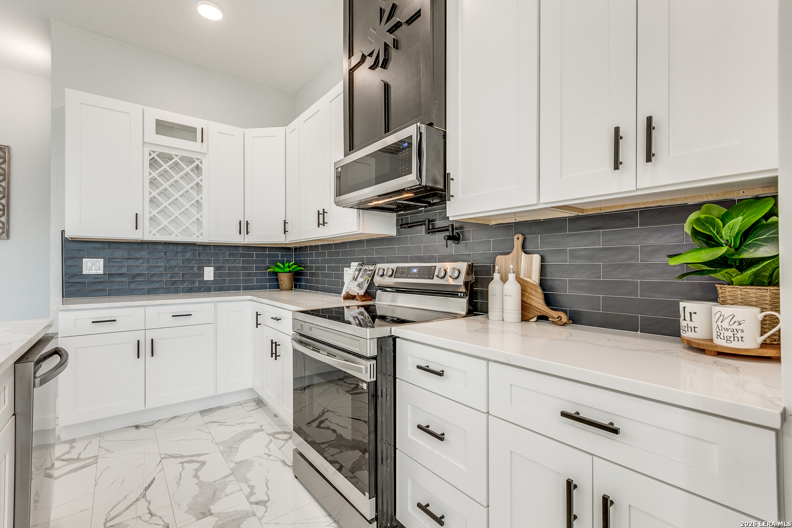 16934 Rancho Atascosa, TX 78002 - Photo 8 of 27 a kitchen with stainless steel appliances white cabinets and a sink