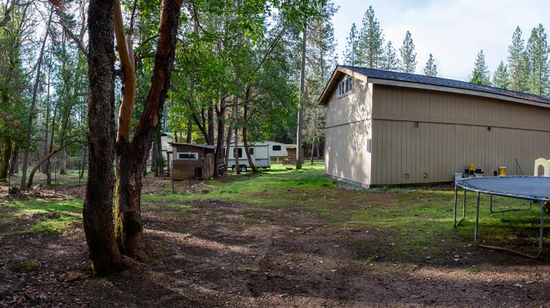 4015 Pleasant Creek Road Rogue River, OR 97537 - Photo 4 of 8 a view of backyard with wooden fence and a large tree