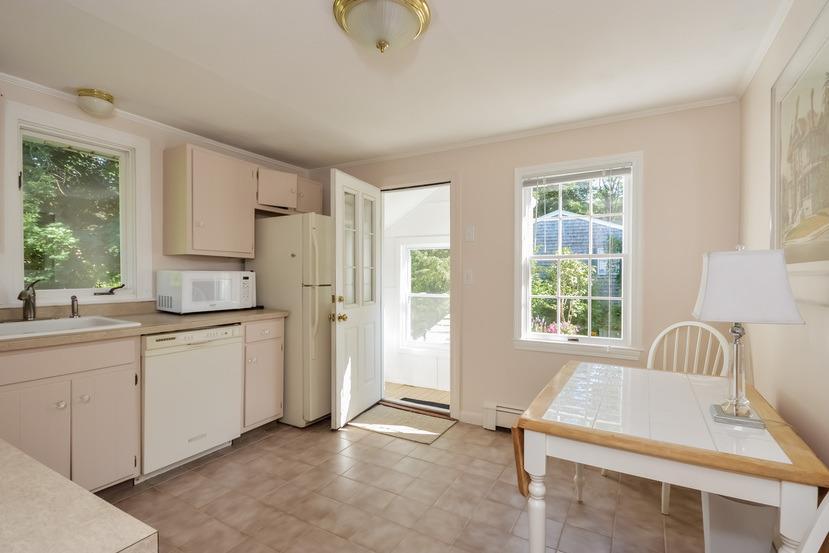 9 Clark Road Sagamore Beach, MA 02562 - Photo 11 of 27 a kitchen with a refrigerator and a sink