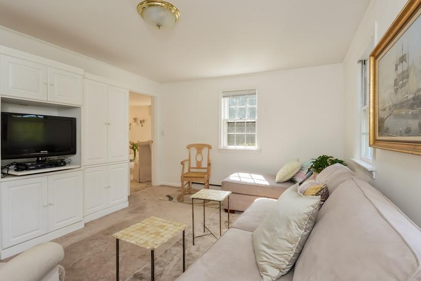 9 Clark Road Sagamore Beach, MA 02562 - Photo 8 of 27 a living room with furniture and a flat screen tv
