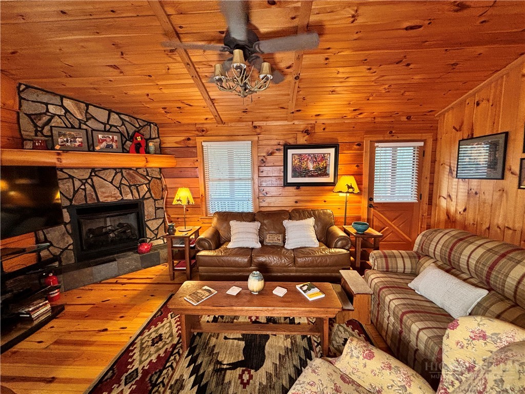 150 Turkey Ridge Crumpler, NC 28617 - Photo 17 of 40 a living room with furniture a fireplace and a flat screen tv