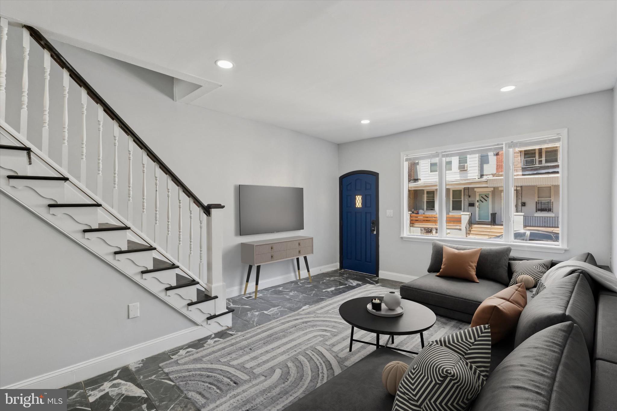 a living room with furniture and a hard wood floor