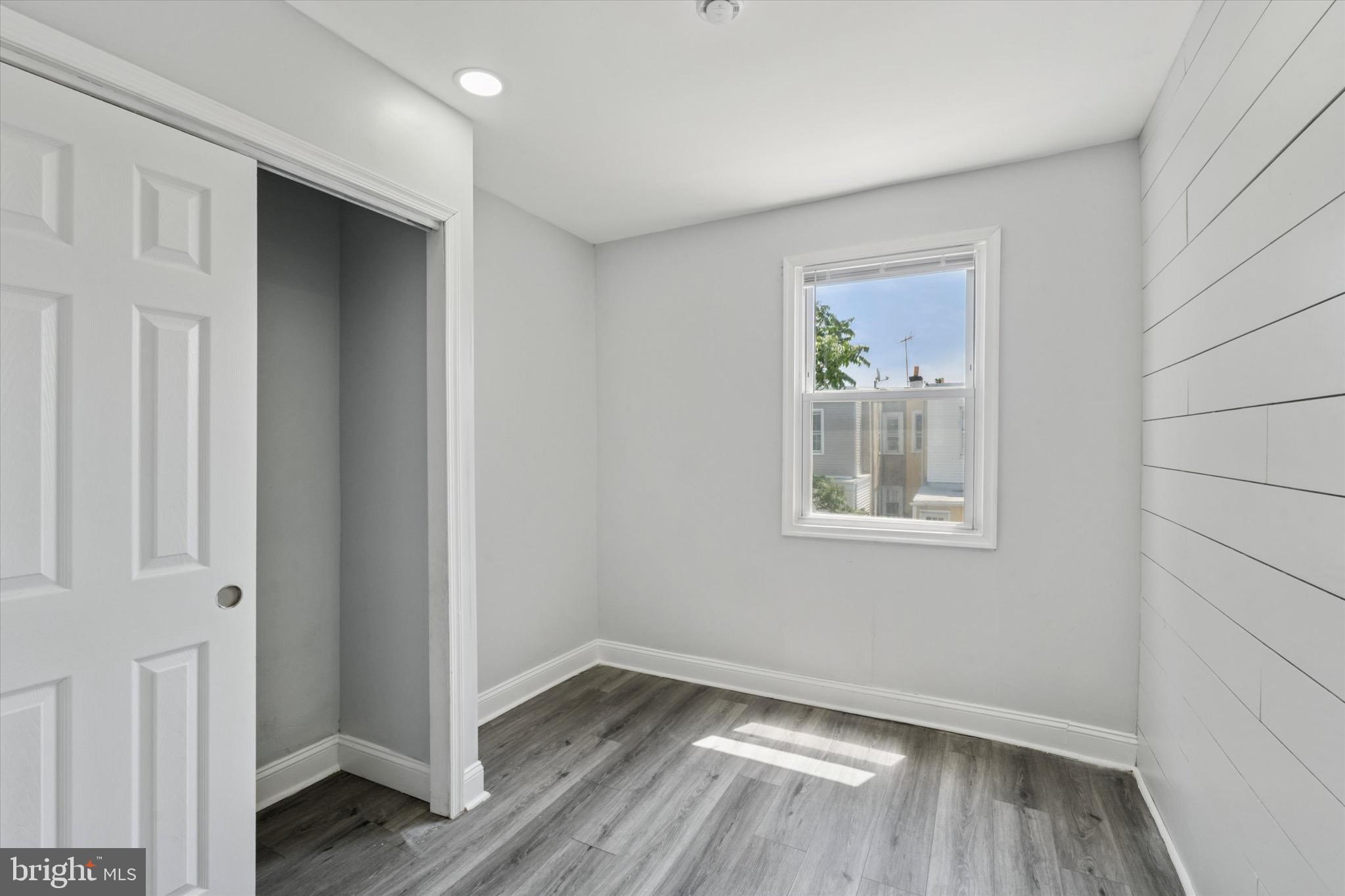3097 Memphis Street Philadelphia, PA 19134 - Photo 12 of 18 a view of an empty room with wooden floor and a window