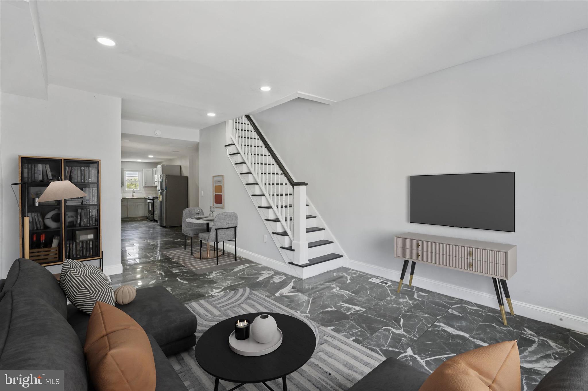 3097 Memphis Street Philadelphia, PA 19134 - Photo 2 of 18 a living room with furniture and a flat screen tv