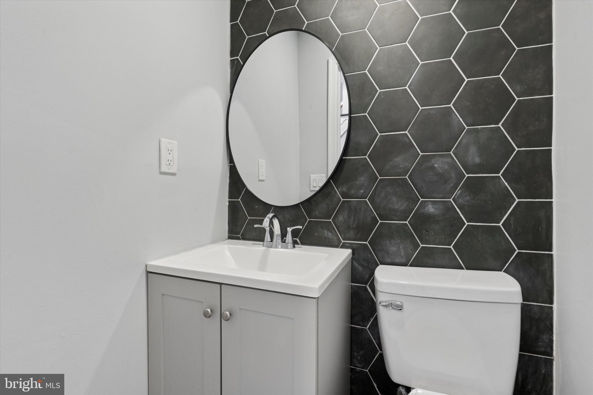 3097 Memphis Street Philadelphia, PA 19134 - Photo 9 of 18 a bathroom with a sink toilet and a mirror