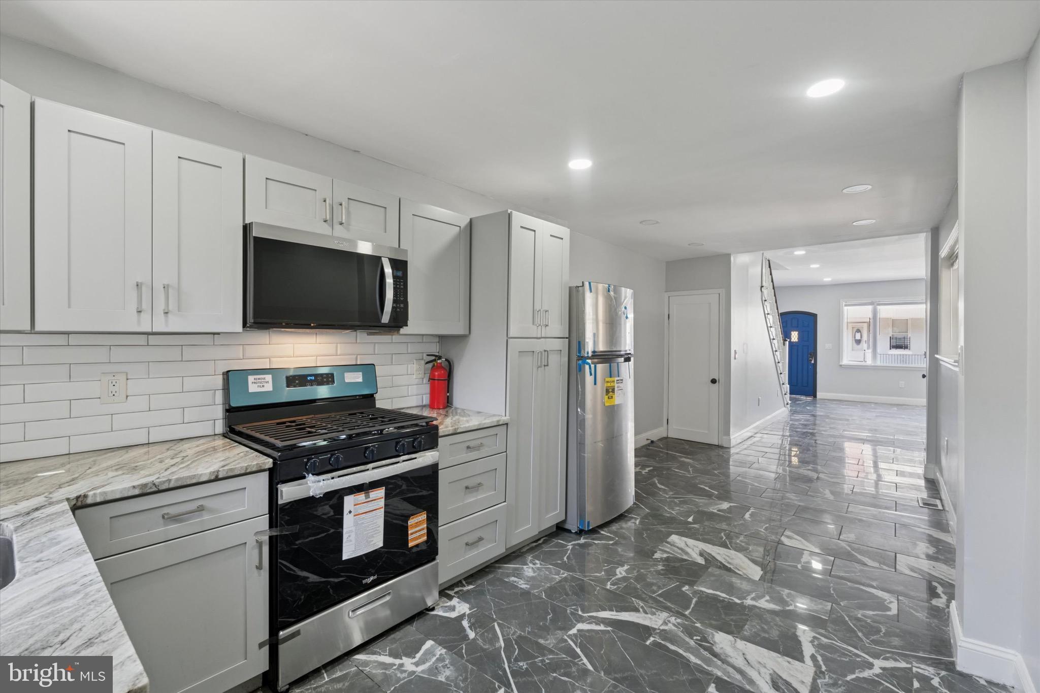 3097 Memphis Street Philadelphia, PA 19134 - Photo 10 of 18 a kitchen with stainless steel appliances a stove a refrigerator and a sink