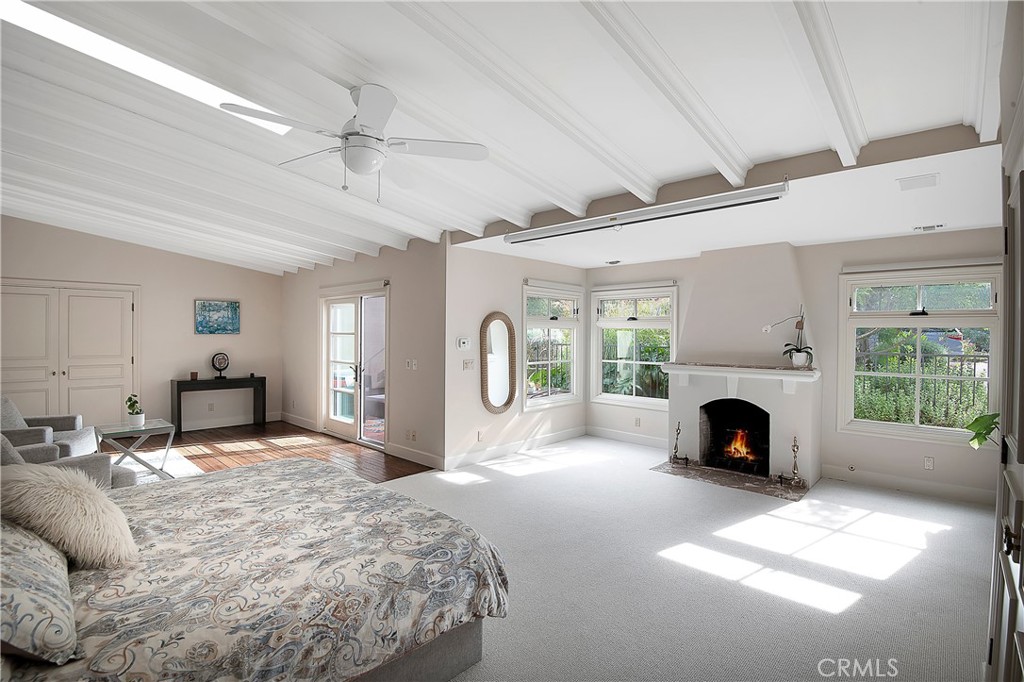 21149 Entrada Road Topanga, CA 90290 - Photo 19 of 39 a spacious bedroom with a large bed and a fireplace