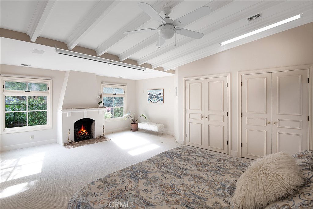21149 Entrada Road Topanga, CA 90290 - Photo 20 of 39 a view of a bedroom with a bed and a fireplace