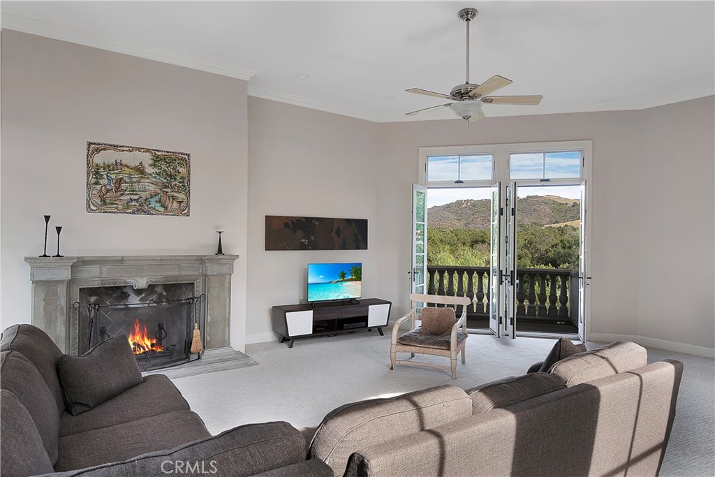 21149 Entrada Road Topanga, CA 90290 - Photo 23 of 39 a living room with furniture a large window and a fireplace
