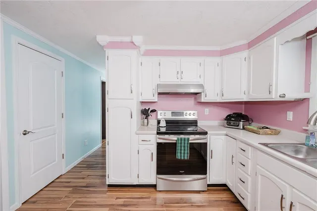 a kitchen with stainless steel appliances granite countertop a stove a sink and a refrigerator