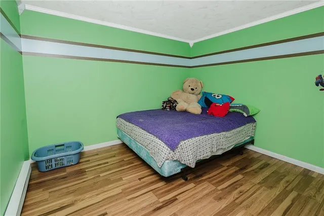 a bed sitting in a bedroom next to a window