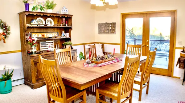 a view of a dining room with furniture and a potted plant