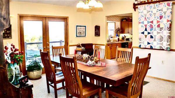 a view of a dining room with furniture and chandelier