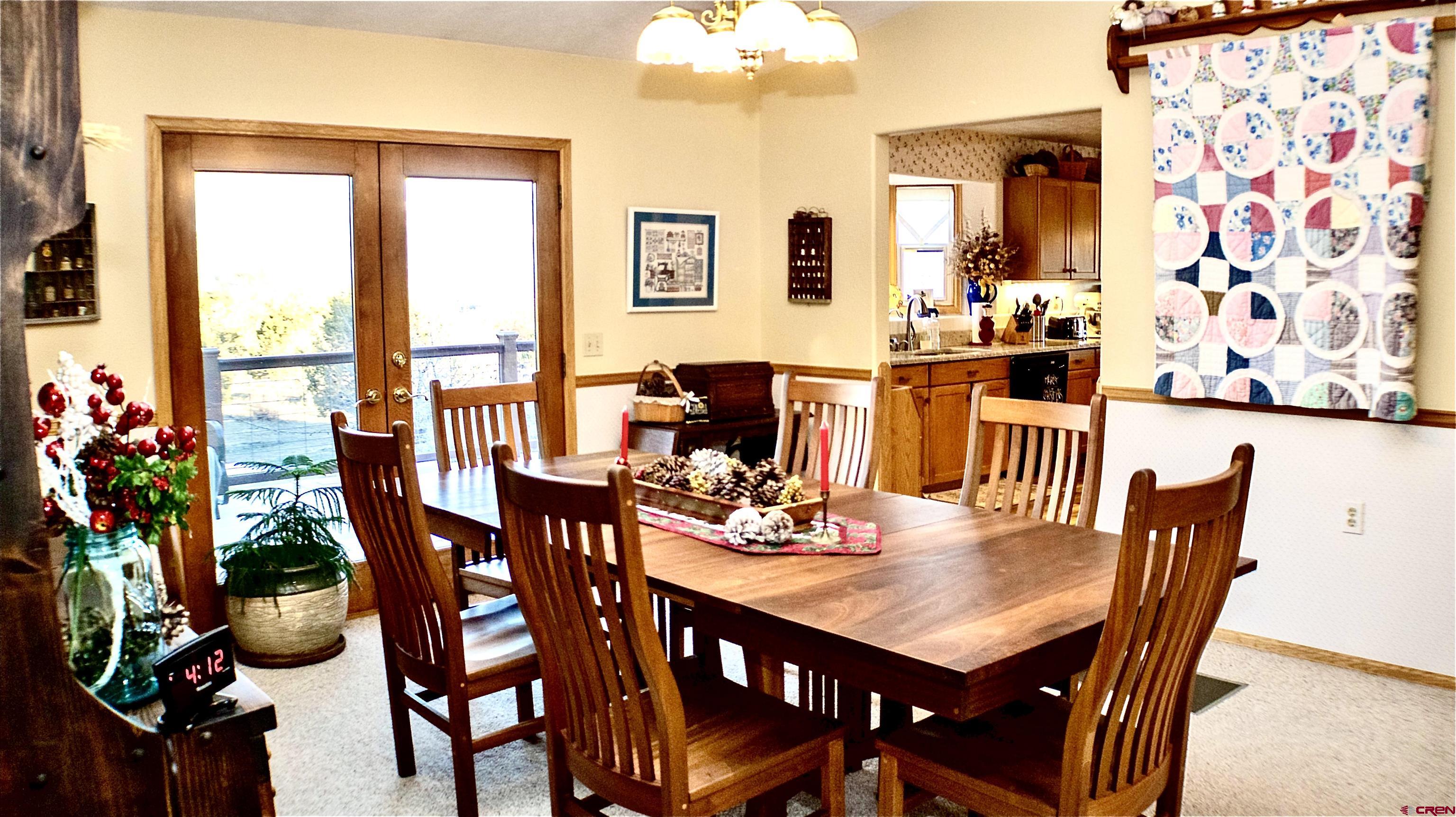 32179 L Road Hotchkiss, CO 81419 - Photo 12 of 45 a view of a dining room with furniture and chandelier