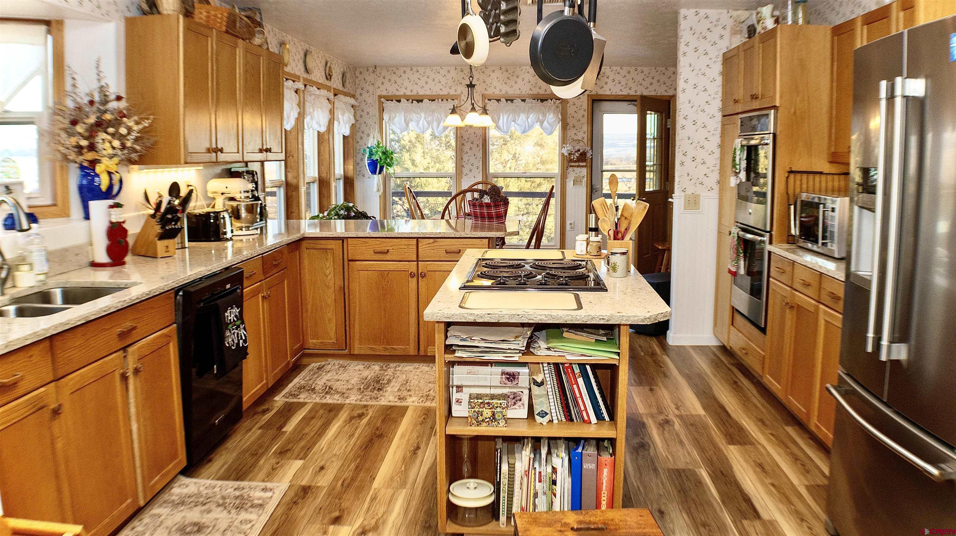 32179 L Road Hotchkiss, CO 81419 - Photo 13 of 45 a kitchen with stainless steel appliances granite countertop a stove and a dining table