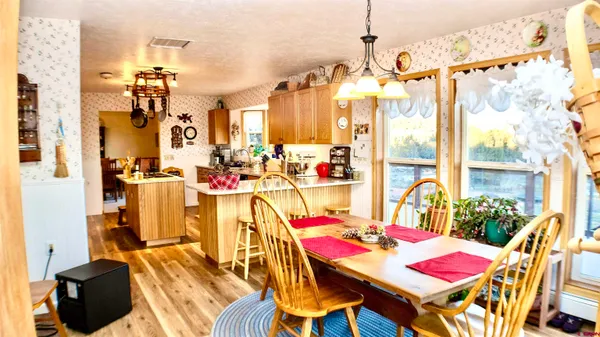 a view of a dining room with furniture and chandelier