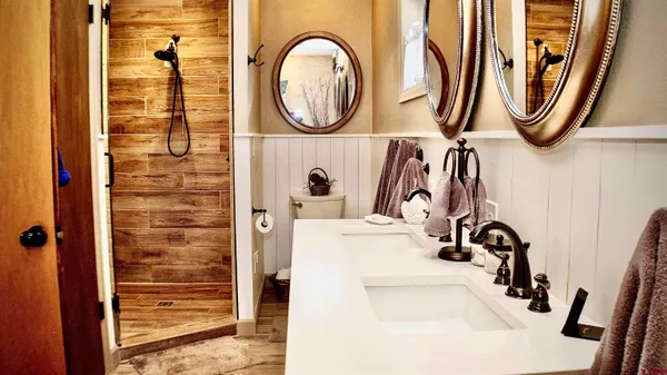 a bathroom with a sink a mirror and a shower curtain