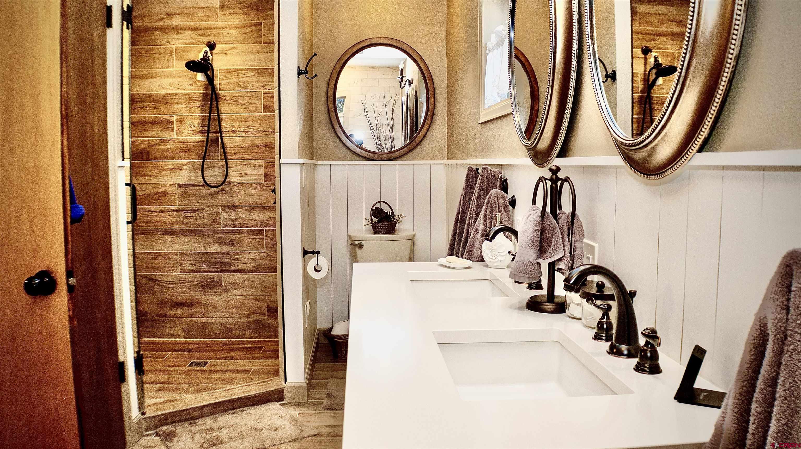 32179 L Road Hotchkiss, CO 81419 - Photo 21 of 45 a bathroom with a sink a mirror and a shower curtain