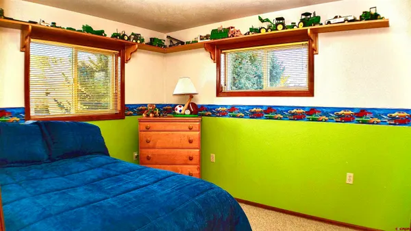a bed room with a bed and a chair