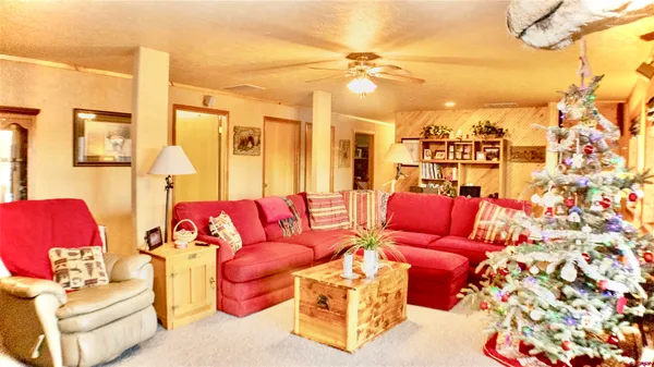 a living room with furniture and a chandelier