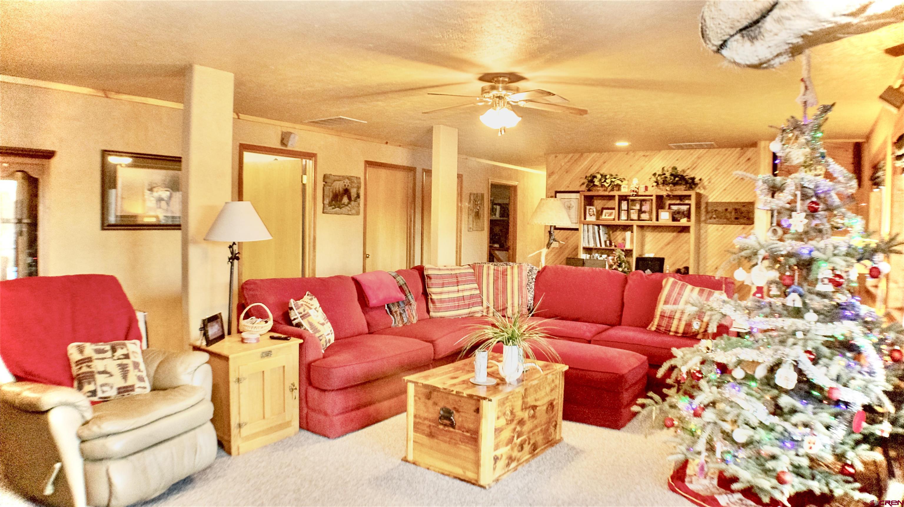 32179 L Road Hotchkiss, CO 81419 - Photo 27 of 45 a living room with furniture and a chandelier