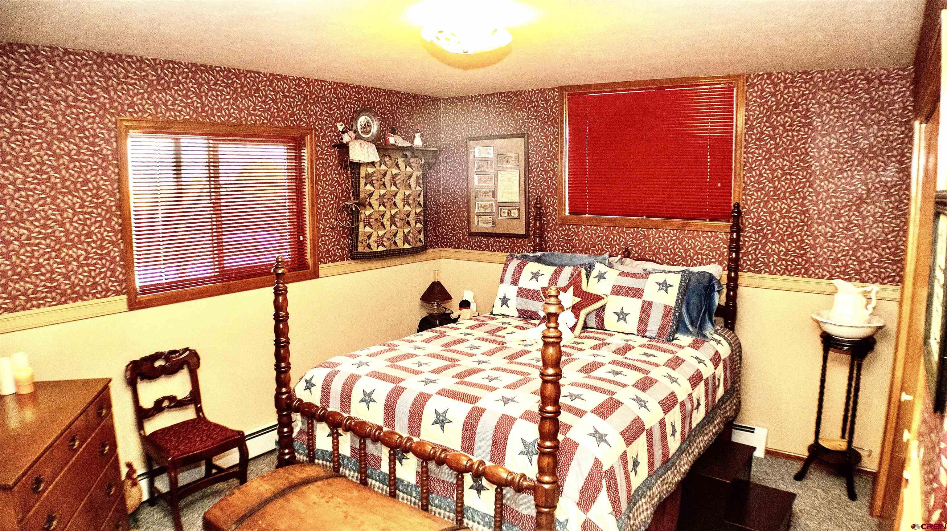32179 L Road Hotchkiss, CO 81419 - Photo 30 of 45 a bedroom with a bed and wooden floor