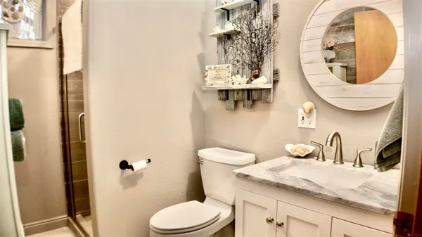a bathroom with a toilet a sink and mirror