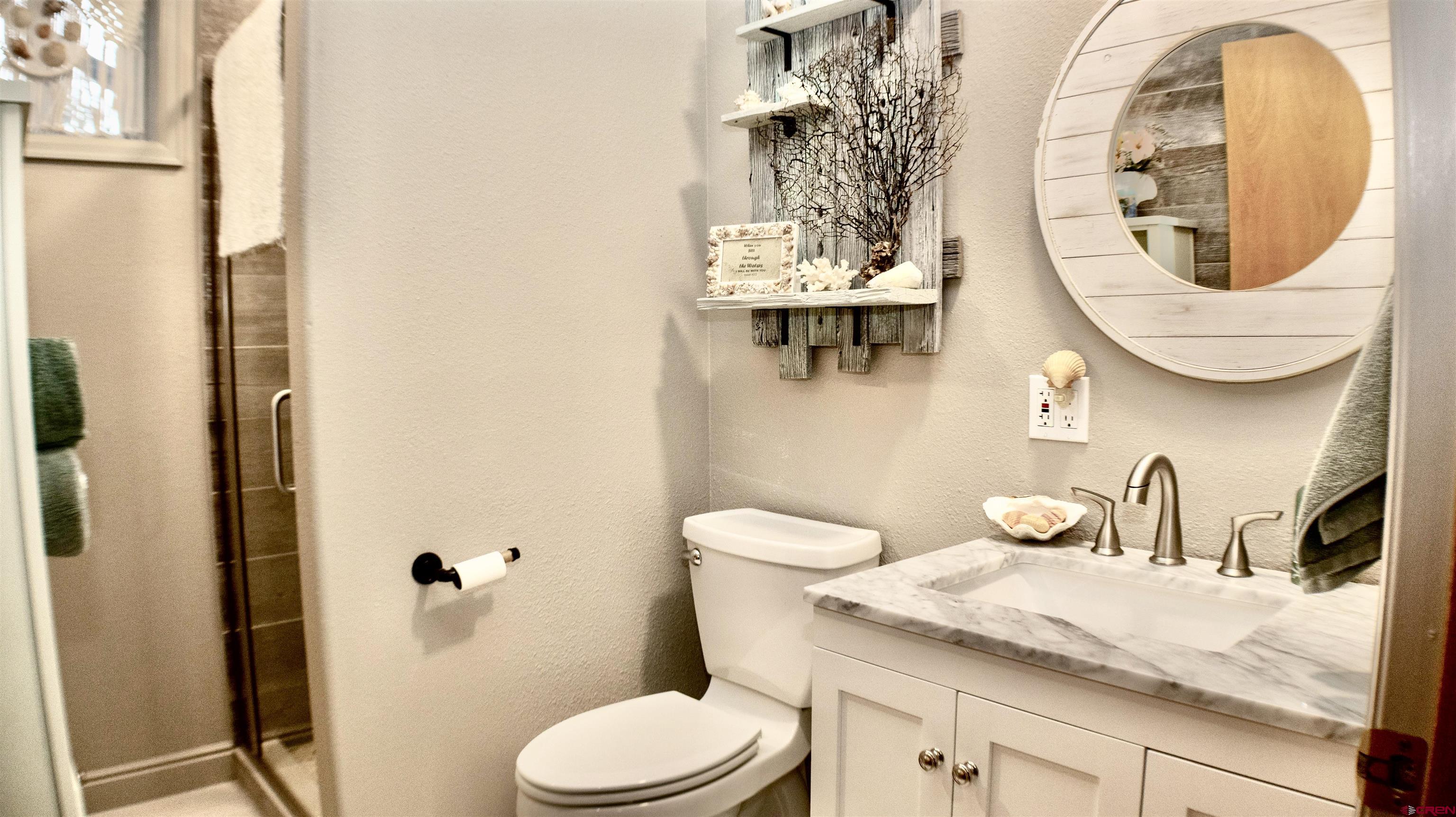 32179 L Road Hotchkiss, CO 81419 - Photo 33 of 45 a bathroom with a toilet a sink and mirror