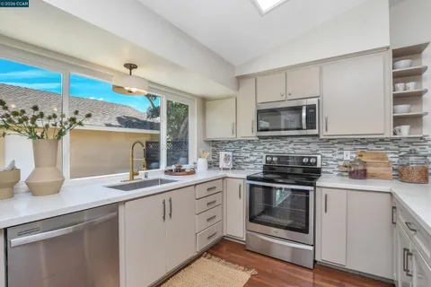 a kitchen with a sink stove and microwave
