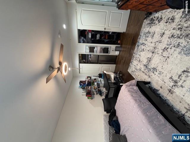 177 Maple Street Fairview, NJ 07022 - Photo 11 of 24 a bedroom with a bed and a dresser