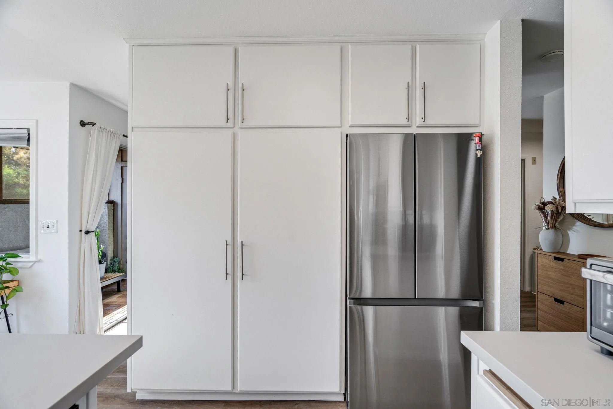 5553 Adobe Falls Road, Unit 1 San Diego, CA 92120 - Photo 6 of 21 a view of kitchen with refrigerator stove and microwave