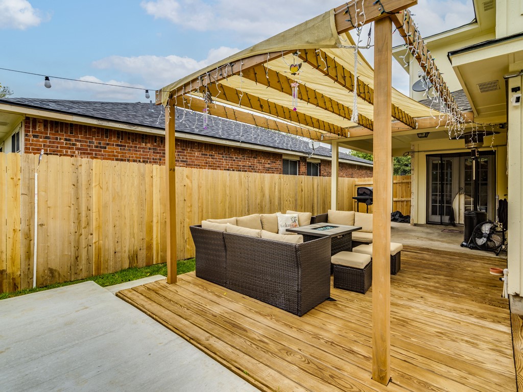 1415 Roxanne's Run Pflugerville, TX 78660 - Photo 27 of 30 An inviting outdoor living space features a spacious wooden deck with a shaded pergola.