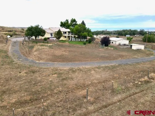 a view of a balcony with wooden floor and fence
