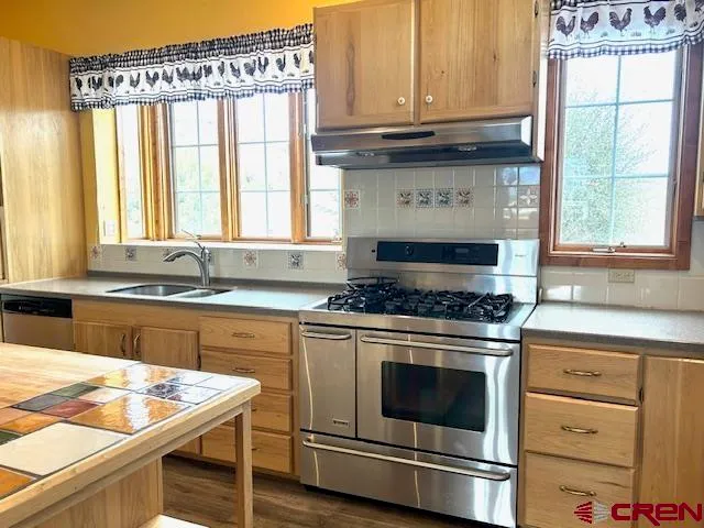 a kitchen with a wooden floor and a refrigerator