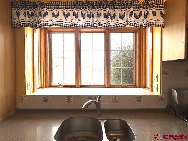 a kitchen with kitchen island granite countertop a sink stove and cabinets