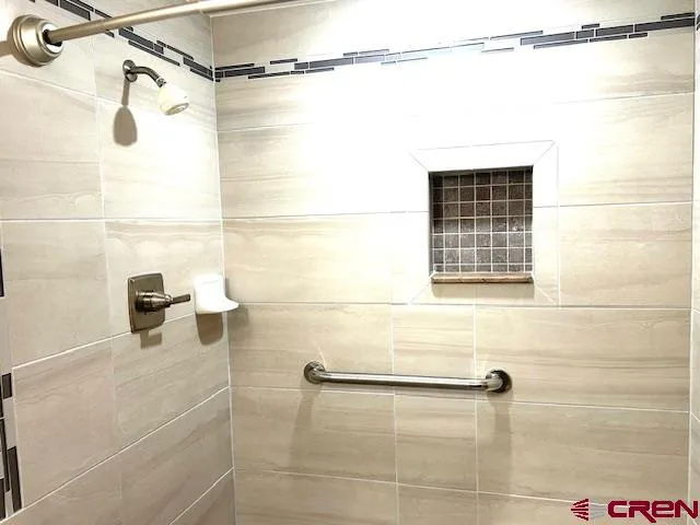 a view of bathroom with a shower and a sink