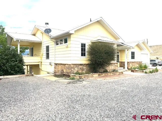 a view of a house with a yard and sitting area