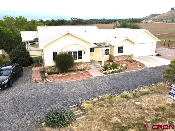 a view of a white house with a yard