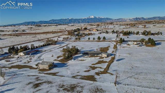 6605 Rio Road Peyton, CO 80831 - Photo 8 of 14 Snowy aerial view with a mountain view