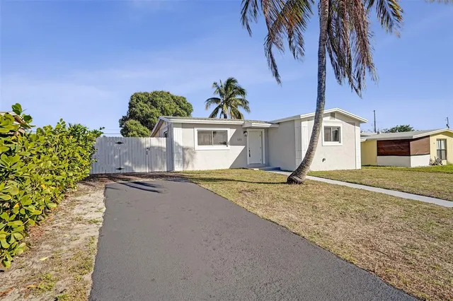 an aerial view of a house with garden space and street view