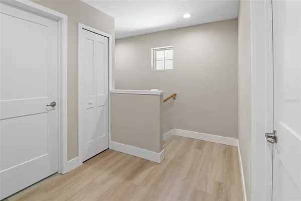 a view of a room with wooden floor