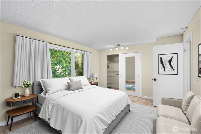 a bedroom with a large bed and a couch