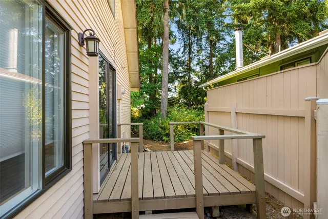 a view of balcony with wooden floor and outdoor seating