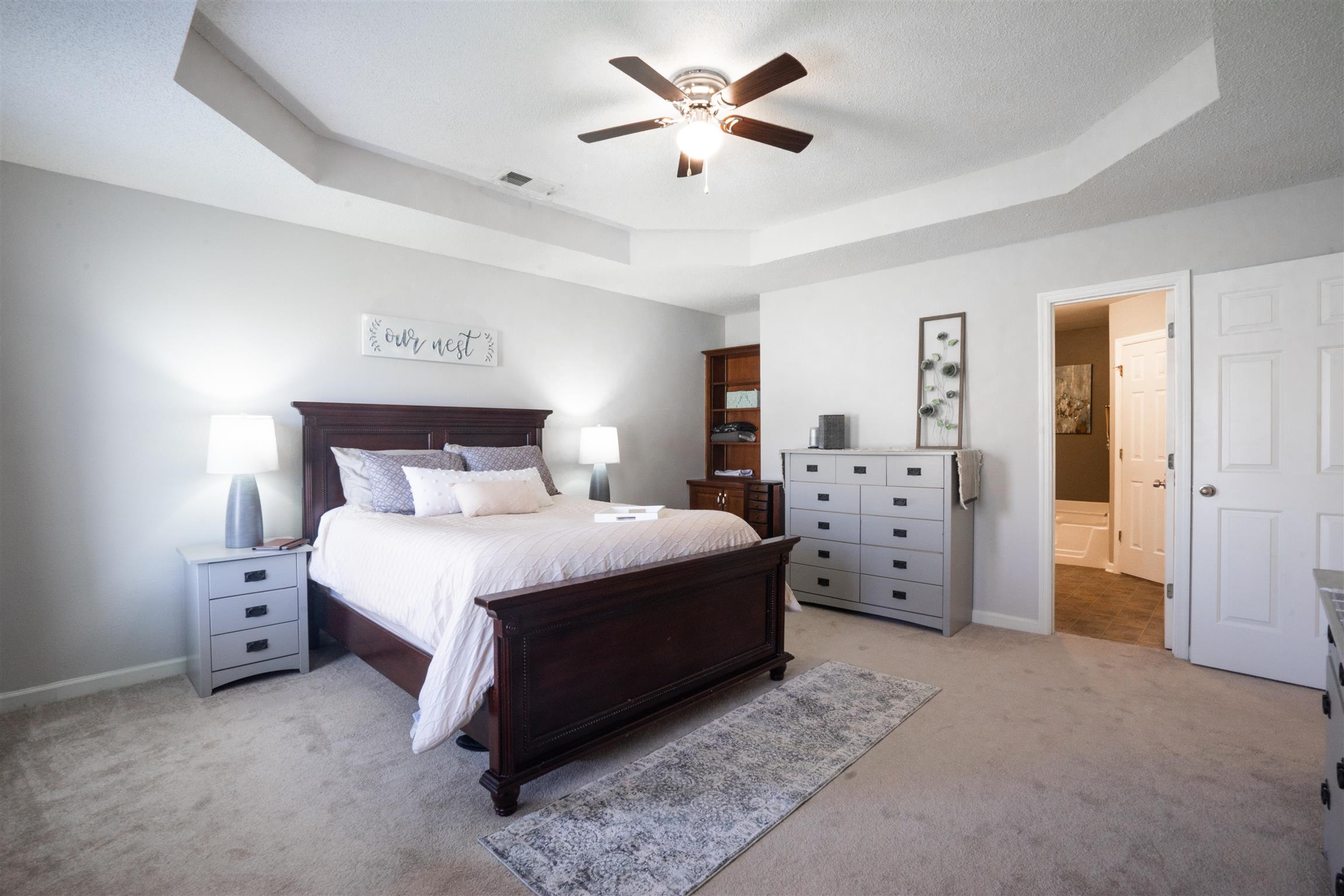 4002 Amber Way Spring Hill, TN 37174 - Photo 14 of 21 a spacious bedroom with a bed and a ceiling fan