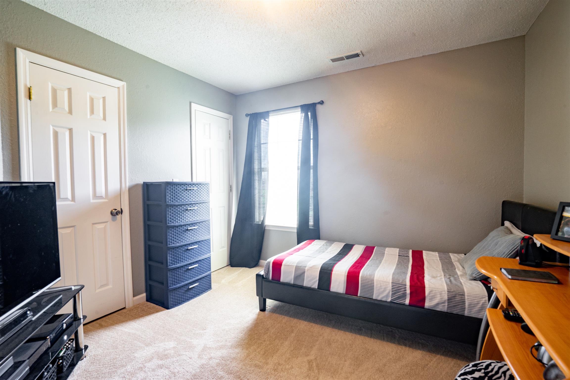 4002 Amber Way Spring Hill, TN 37174 - Photo 17 of 21 a bedroom with a bed and flat screen tv